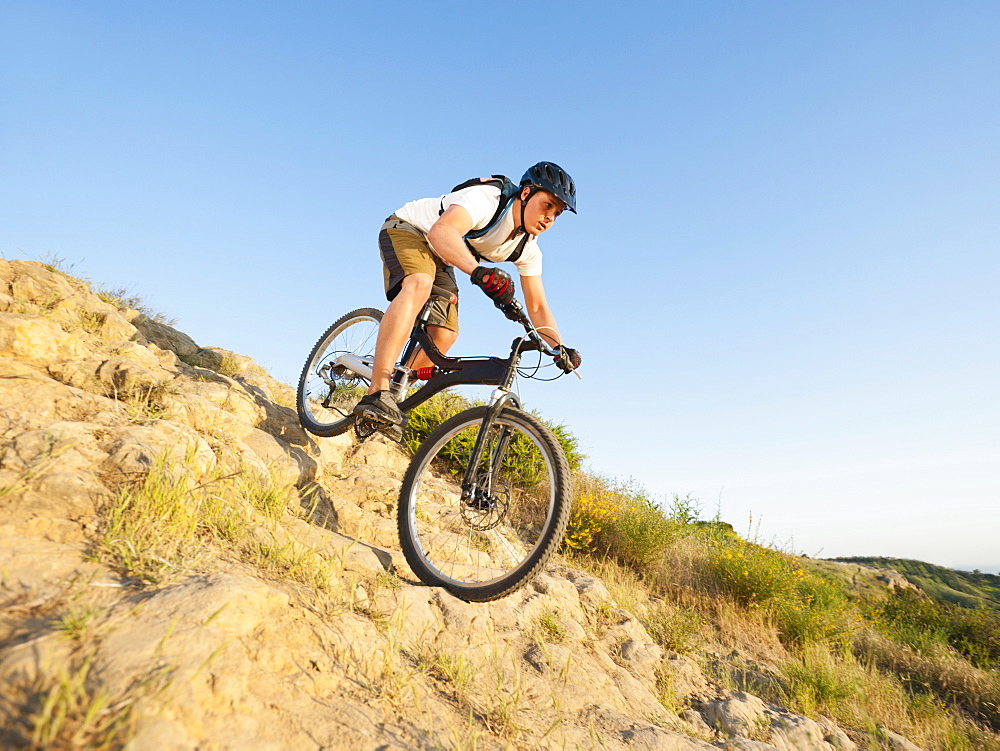 USA, California, Laguna Beach, Man cycling down hill
