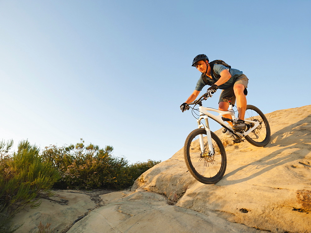 USA, California, Laguna Beach, Man cycling down hill