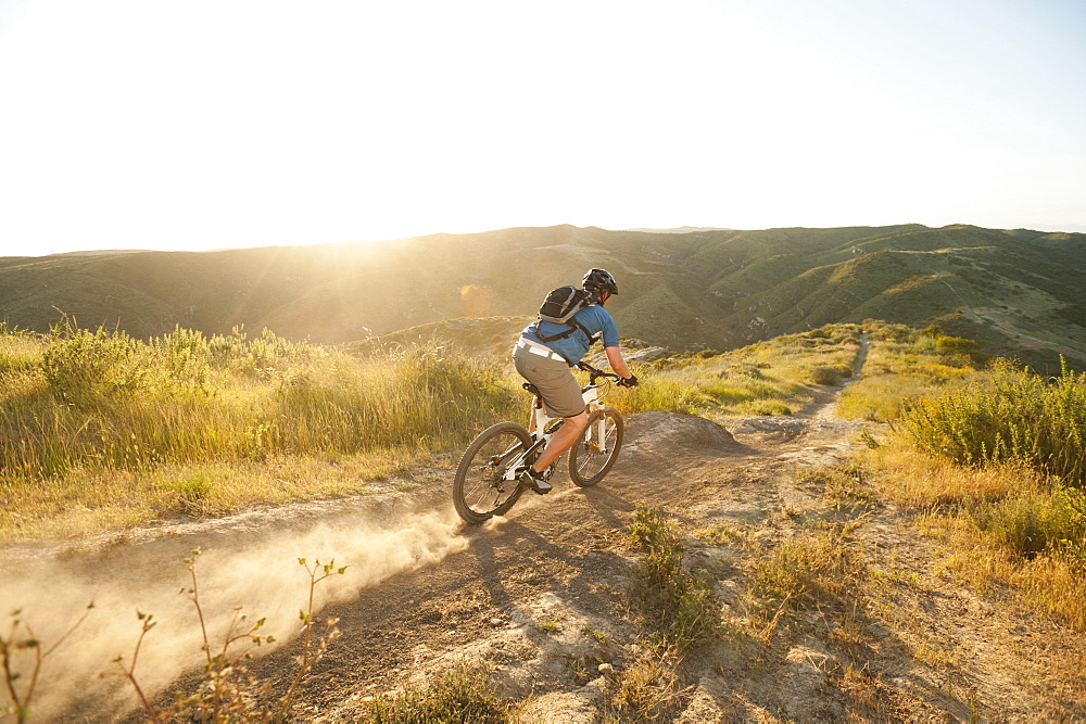 USA, California, Laguna Beach, Man cycling down hill