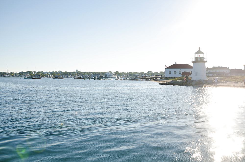 Brant Point Lighthouse and harbor with water reflecting sunlight