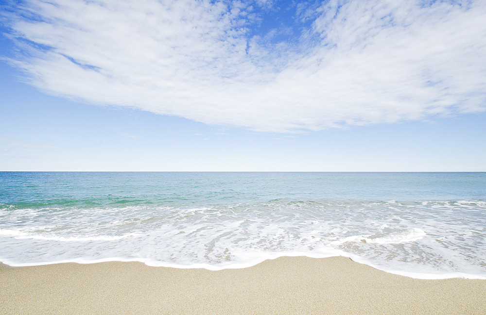 Ocean waves on sandy beach