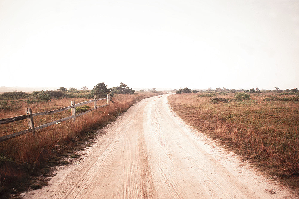 Dirt road crossing grassy fields leading to Cisco Beach