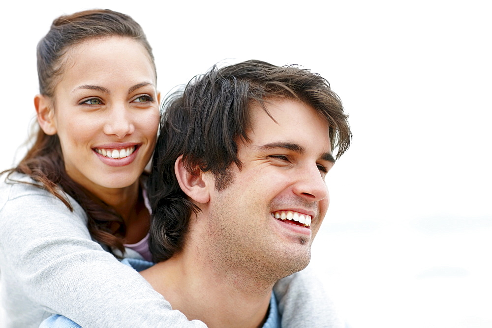 Man giving woman a piggy back ride