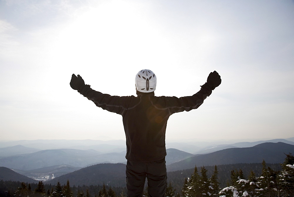 Snowboarder at top of ski hill