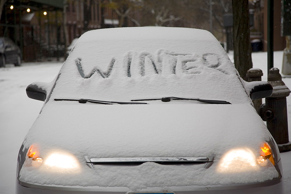 Parked car covered in snow