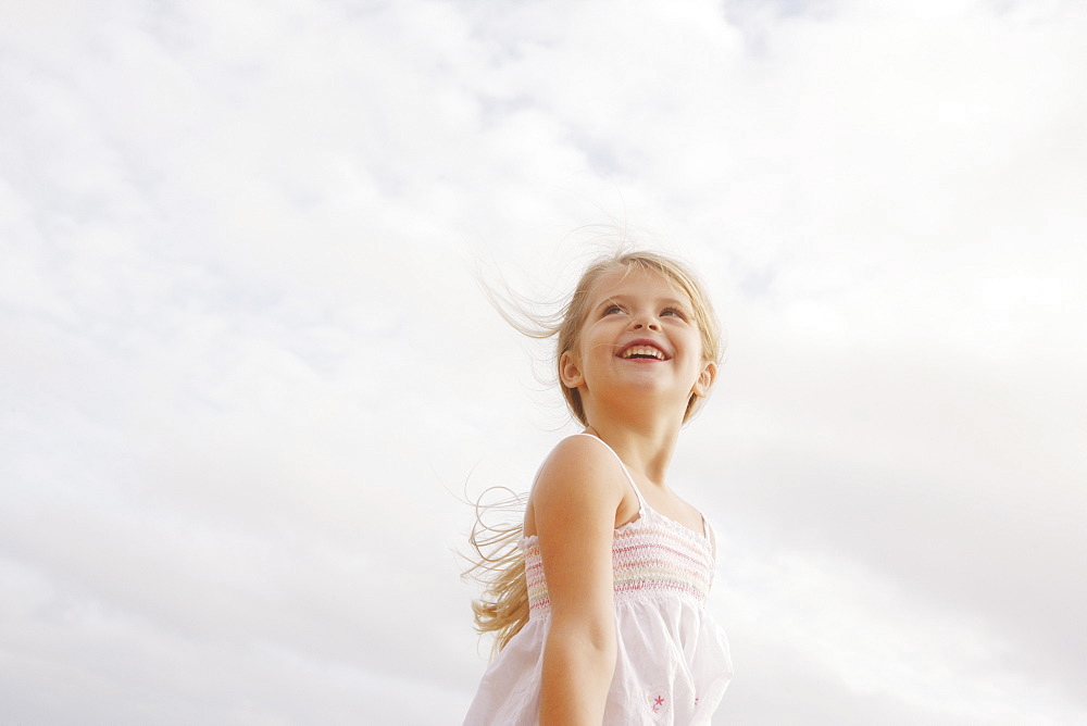 Low angle view of girl looking up