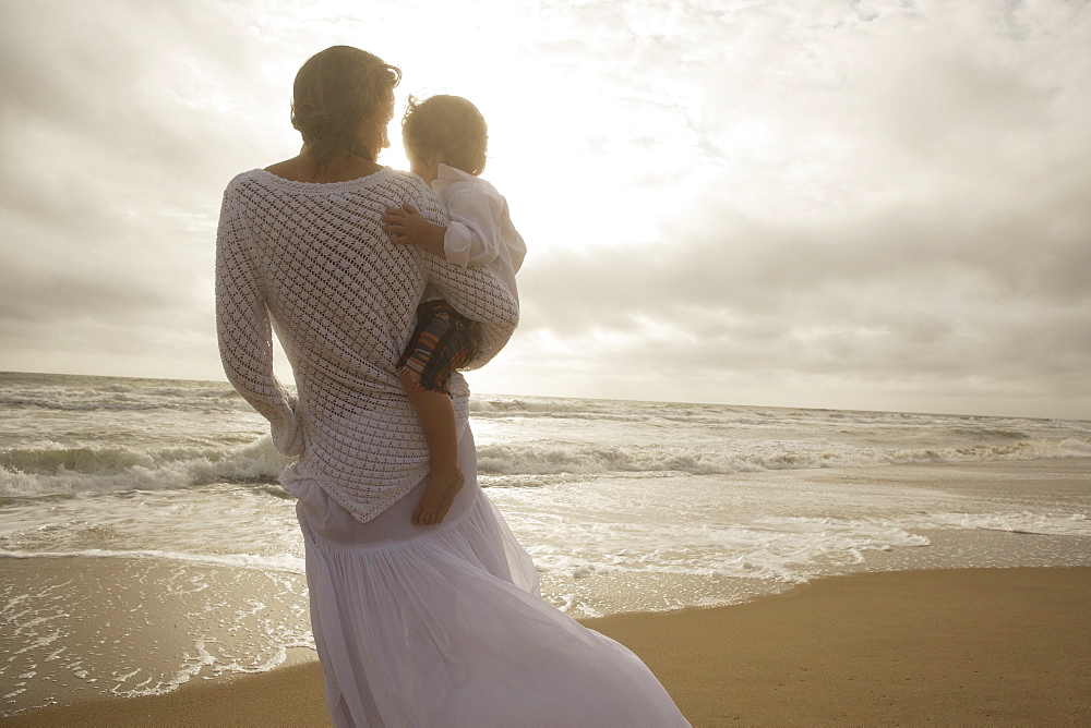 Mother holding child at beach