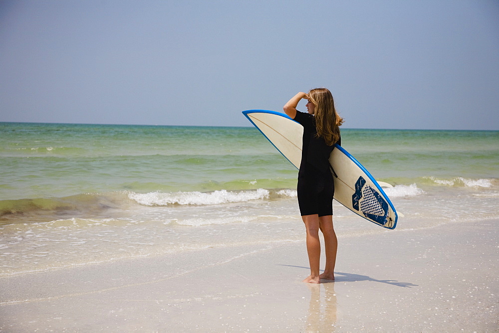 Girl holding surfboard, Florida, United States