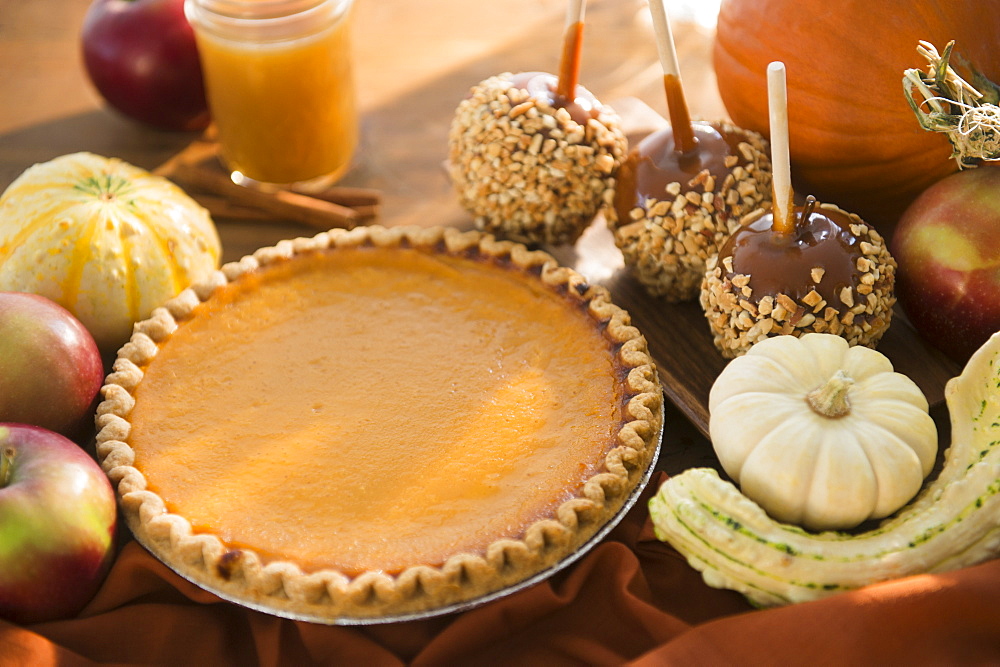 Studio Shot of homemade pumpkin pie and caramel apples