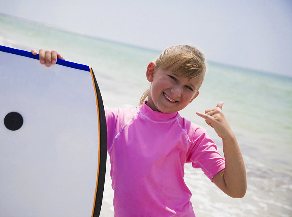 Young girl holding boogie board, Florida, United States