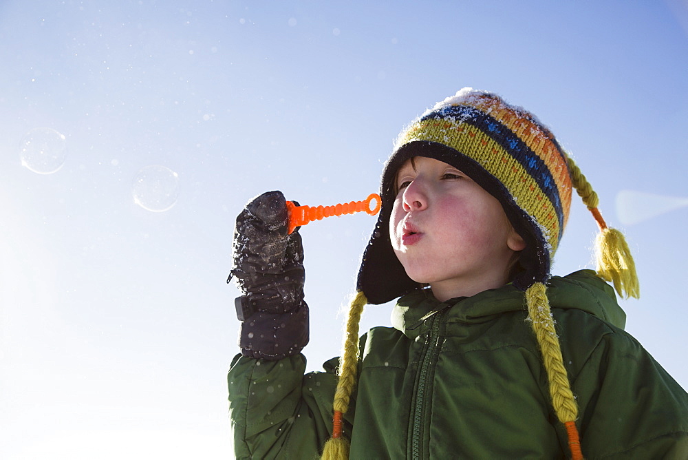 Boy (4-5) playing with bubbles