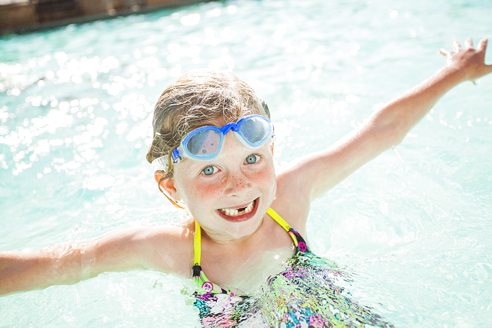 Girl (4-5) playing in swimming pool