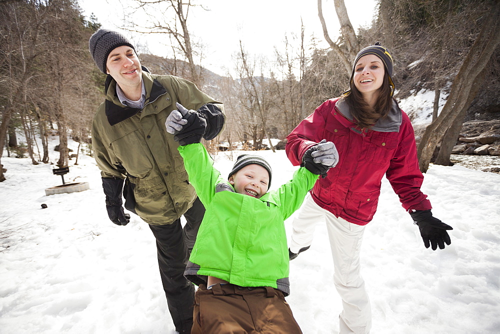 Front view of boy (4-5) with parents during stroll, USA, Utah, Highland