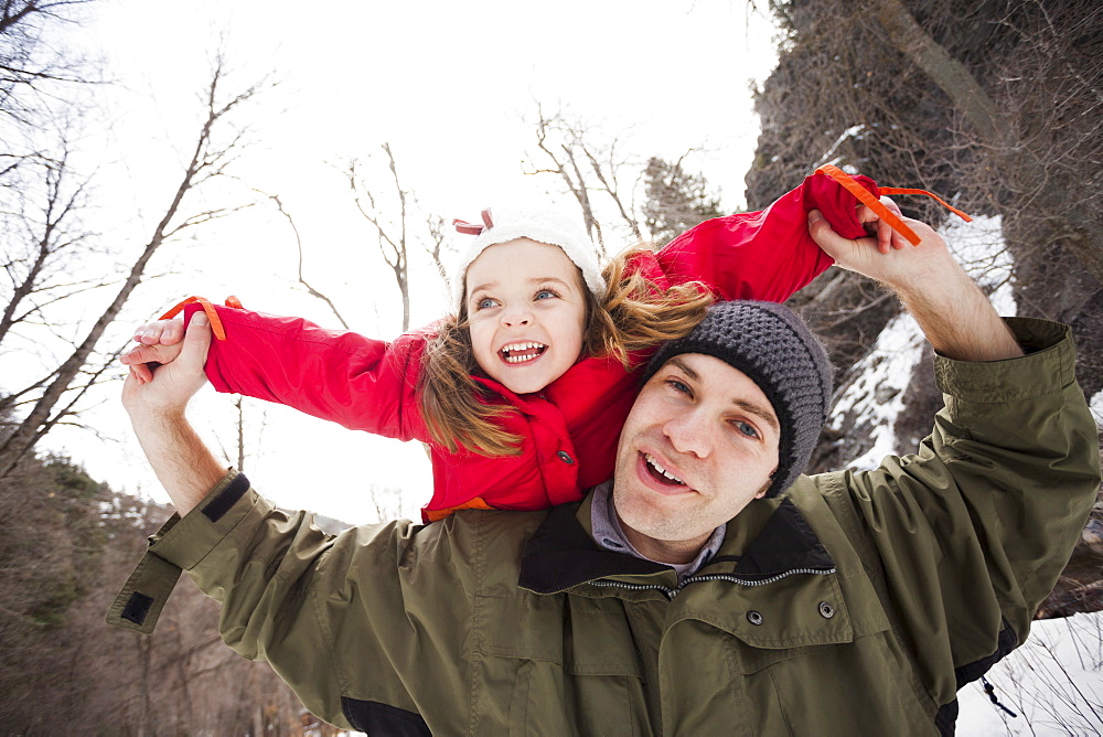 Portrait of young man carrying girl (2-3) on shoulders, USA, Utah, Highland