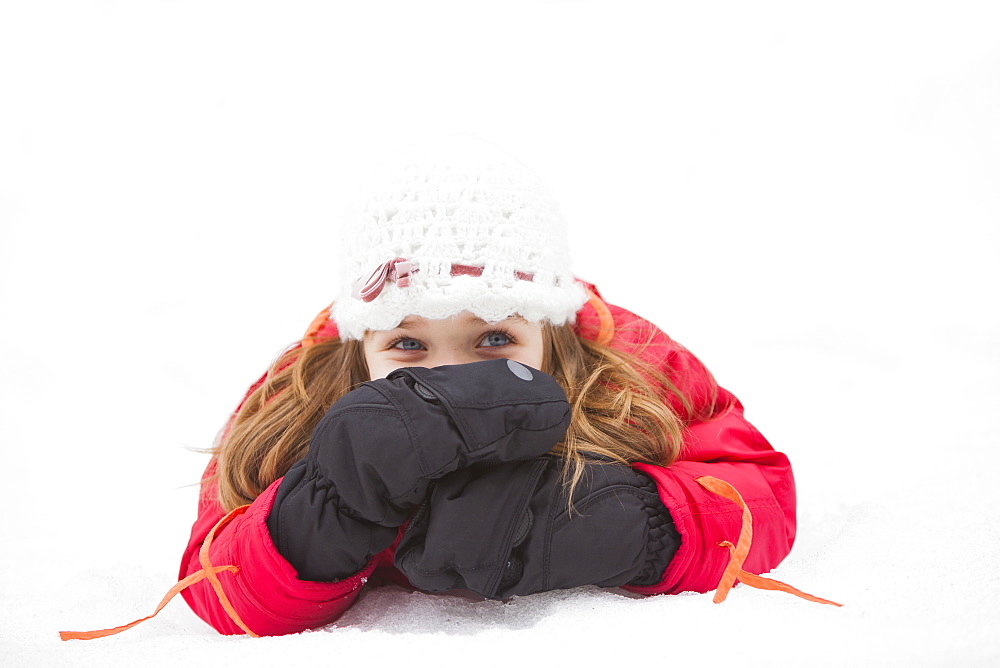 Portrait of girl (2-3) lying on snow