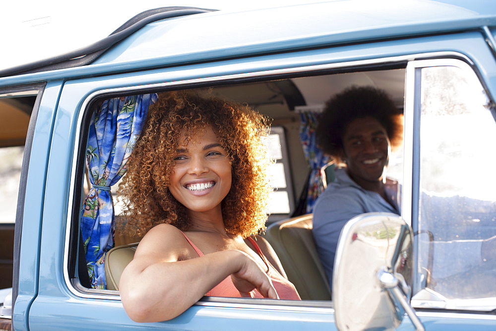 Smiling woman and man in van