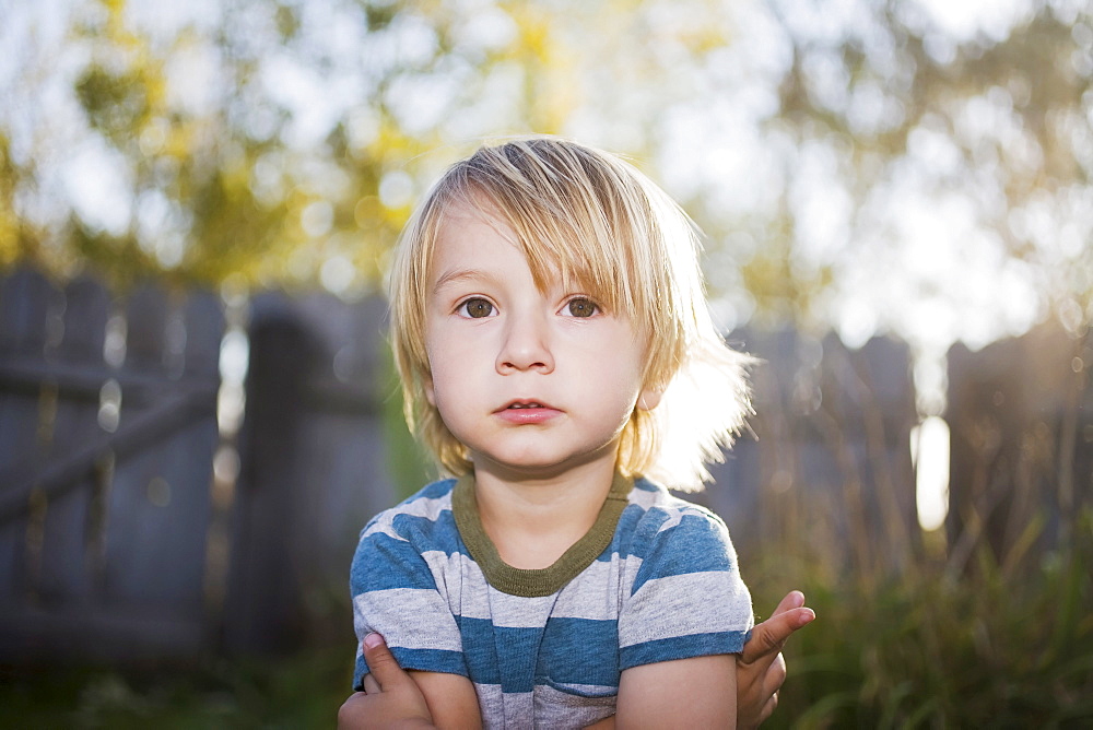 Toddler boy with arms crossed, Colorado, USA