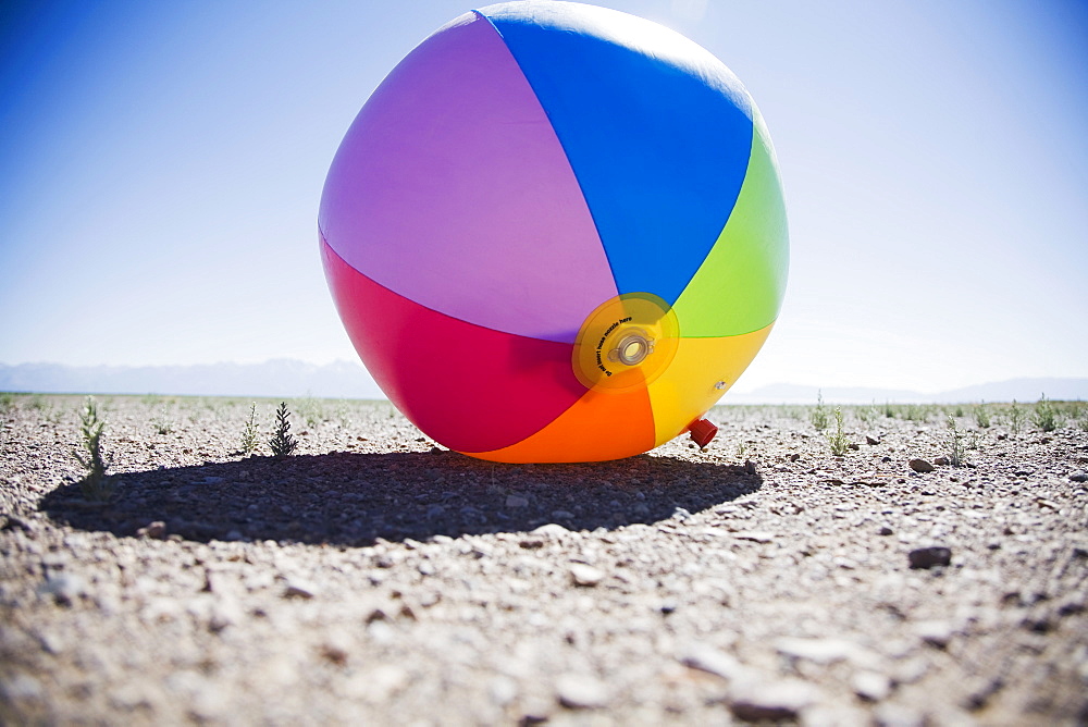 Beach ball in dry field, Colorado, USA