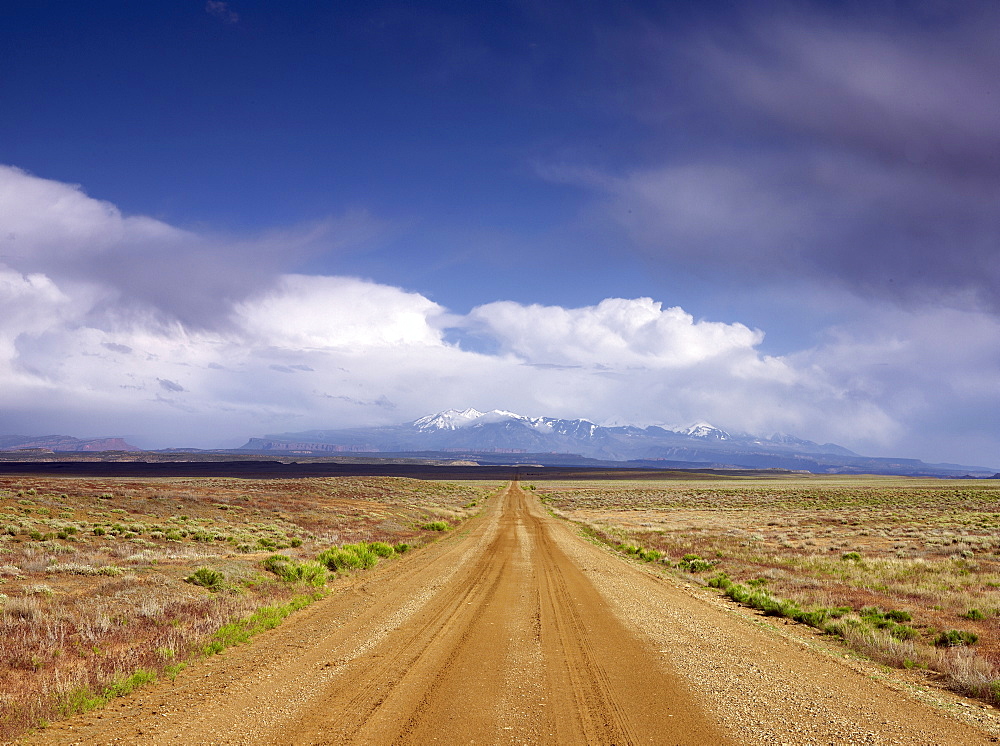 USA, Utah, Dirt road crossing landscape