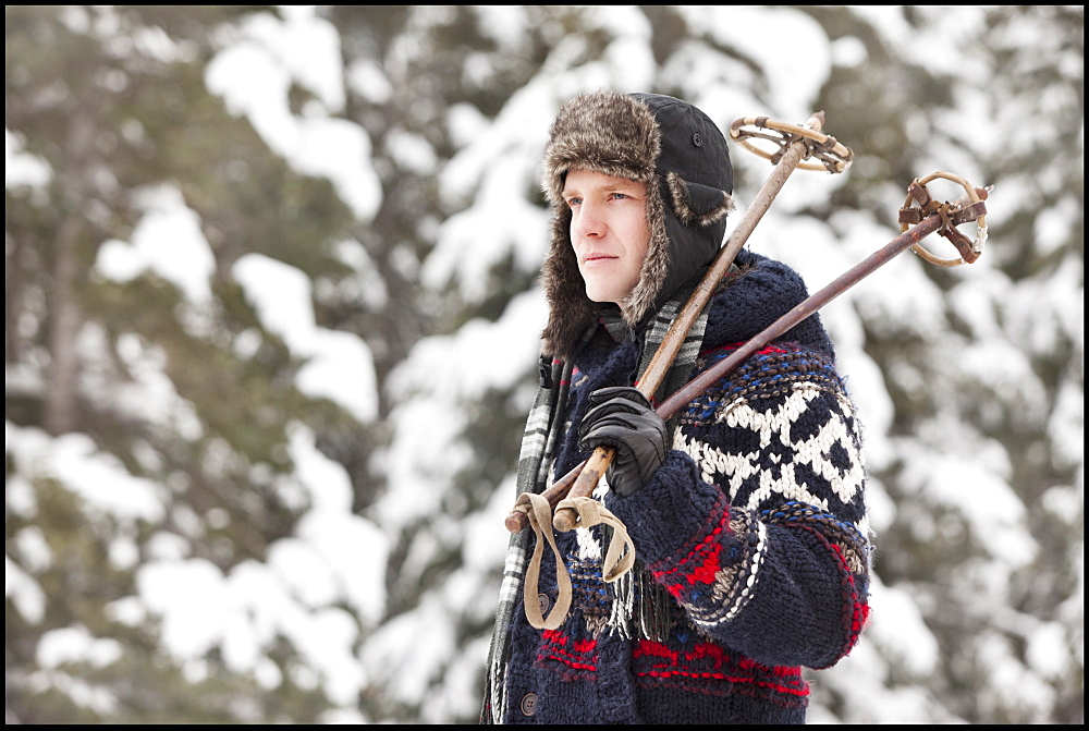 USA, Utah, Salt Lake City, man carrying ski poles