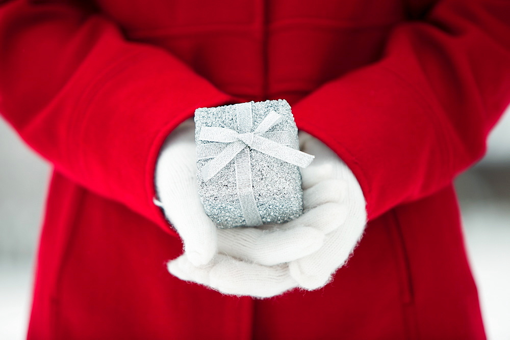 Young woman holding Christmas gift