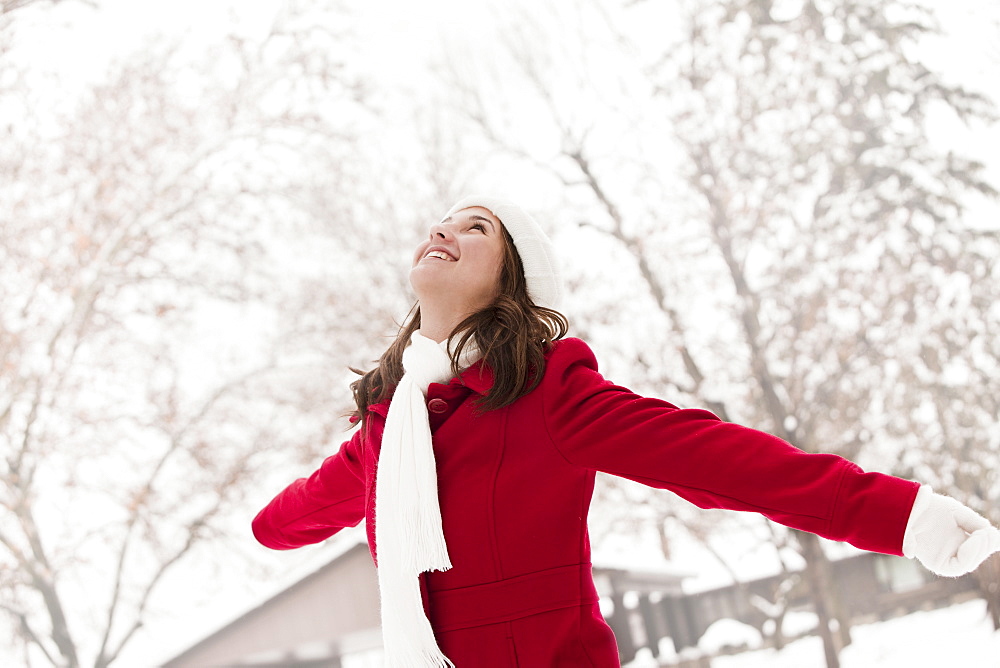 USA, Utah, Lehi, Young woman standing in snow