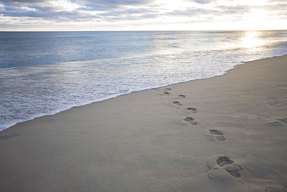 USA, Massachusetts, Cape Cod, footprints on beach at sunset