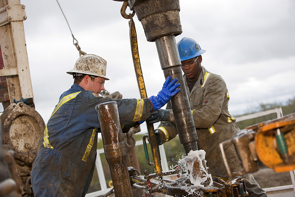 Oil workers drilling for oil on rig