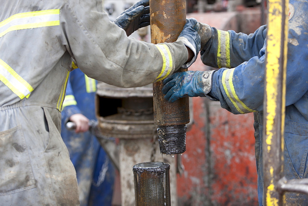 Oil workers drilling for oil on rig