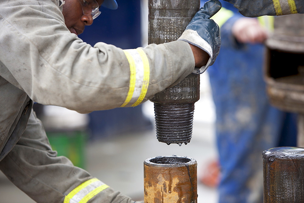 Oil worker drilling for oil on rig