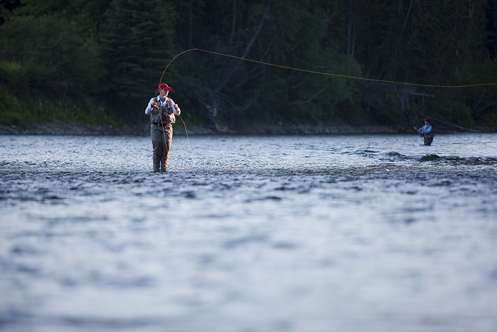 Canada, British Columbia, Fernie, Woman fly fishing in river