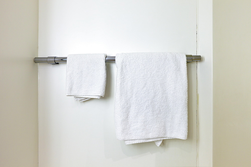 Towels hanging on rail in bathroom