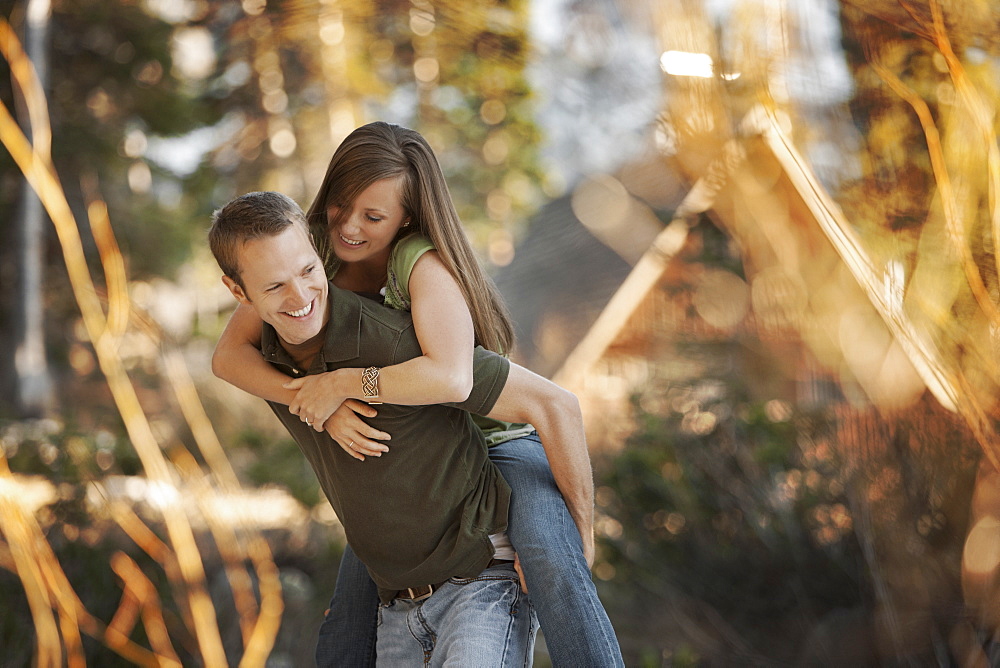 Man giving girlfriend a piggyback ride