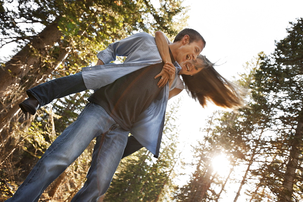 Man giving girlfriend a piggyback ride