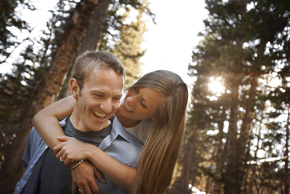 Man giving girlfriend a piggyback ride