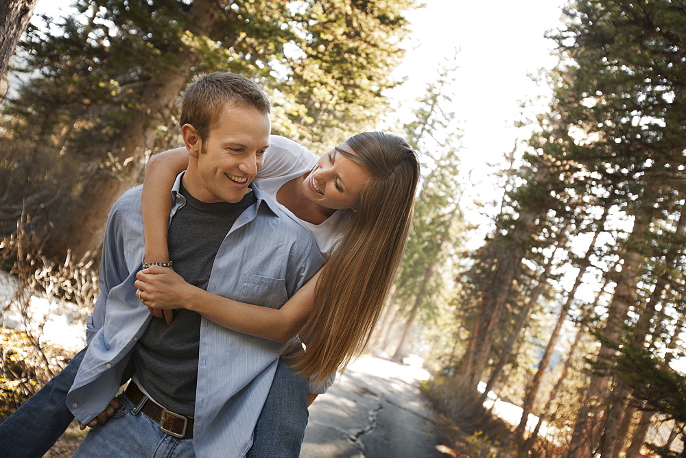 Man giving girlfriend a piggyback ride