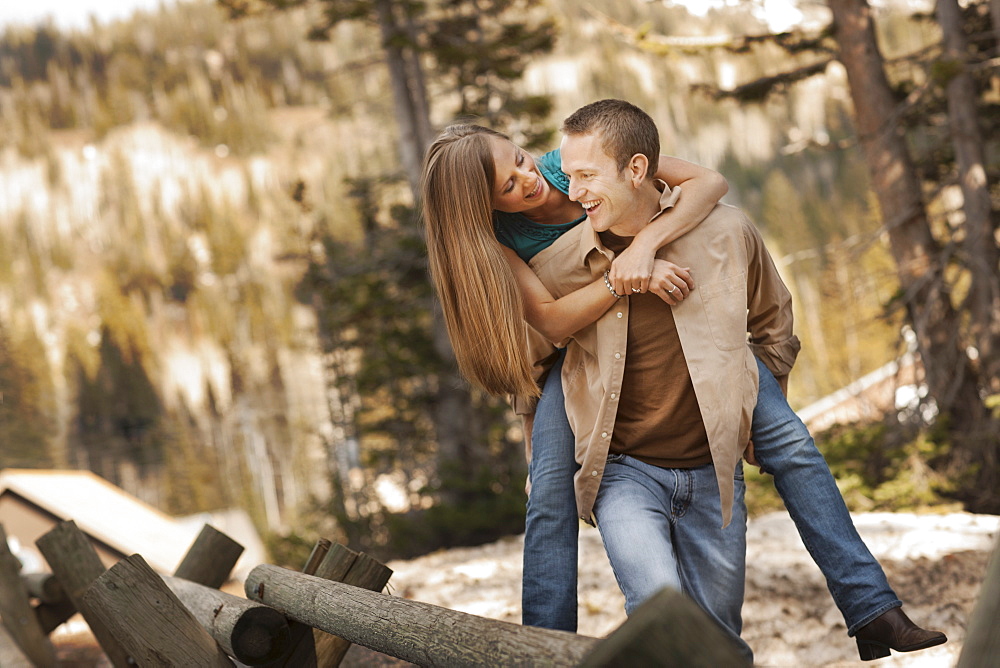 Man giving girlfriend a piggyback ride