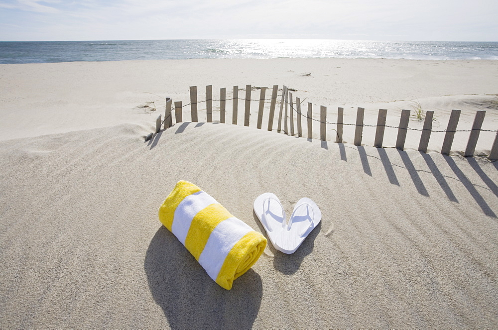 Towel and flip flops on the beach