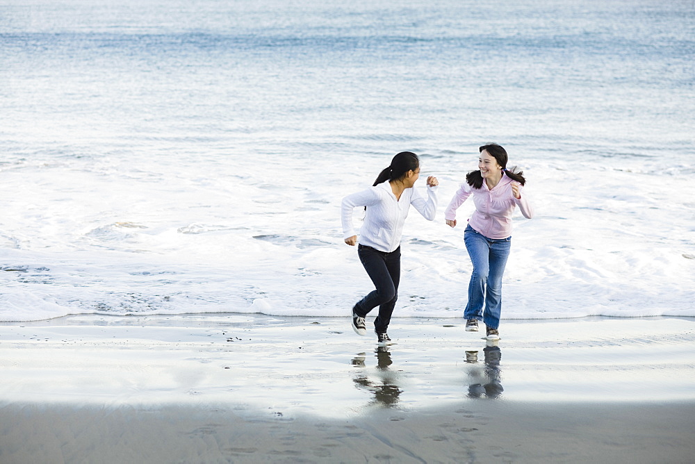 Girls running on beach
