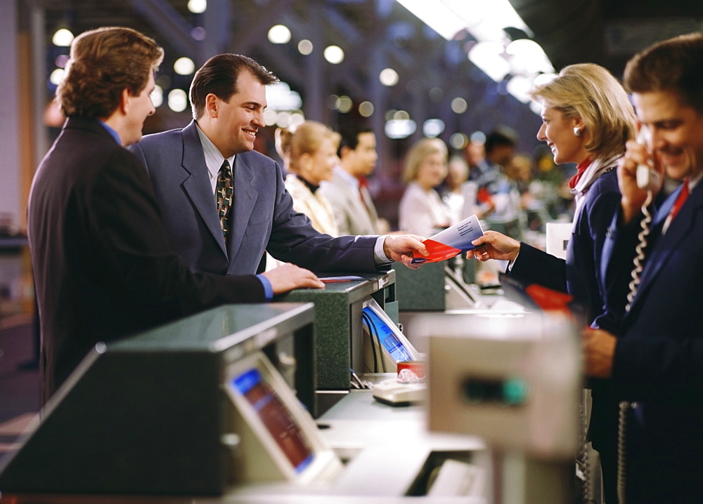 Businessman buying ticket at the airport