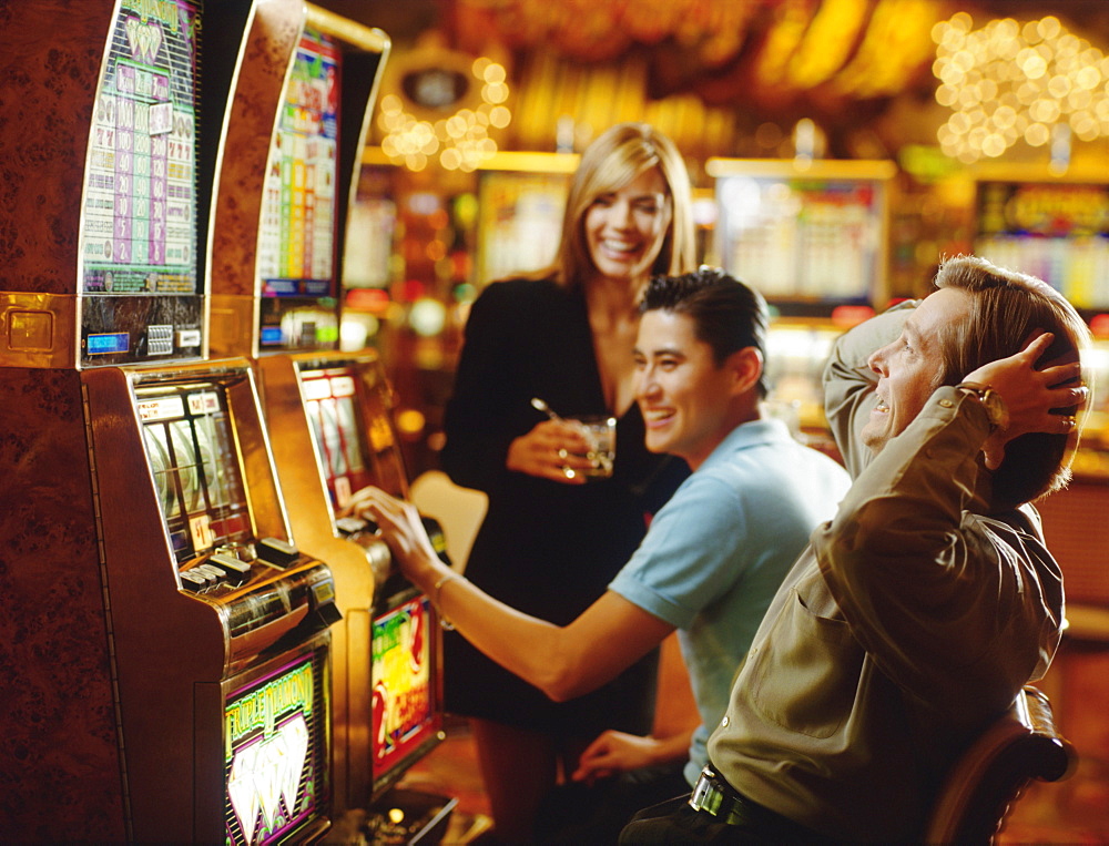 People in casino playing on slot machines