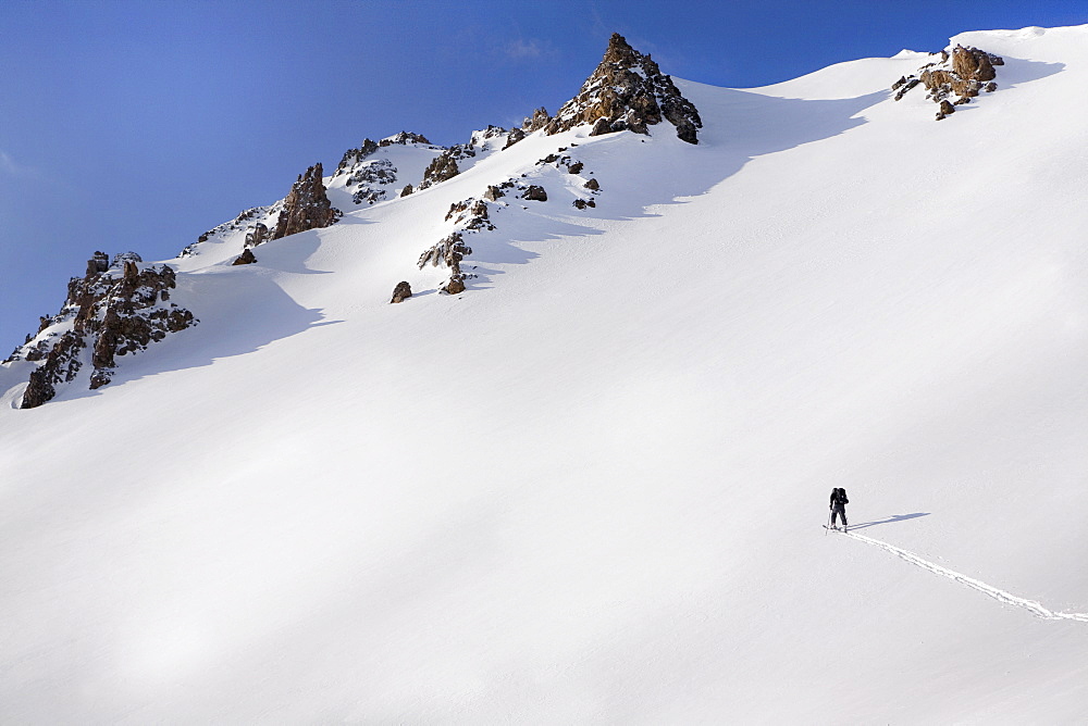 Person walking in snow up mountain, Aspen, Colorado, USA 