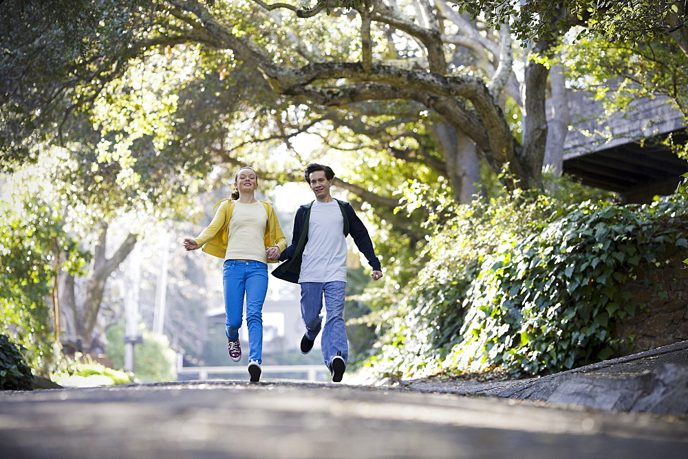 Young couple running on country road