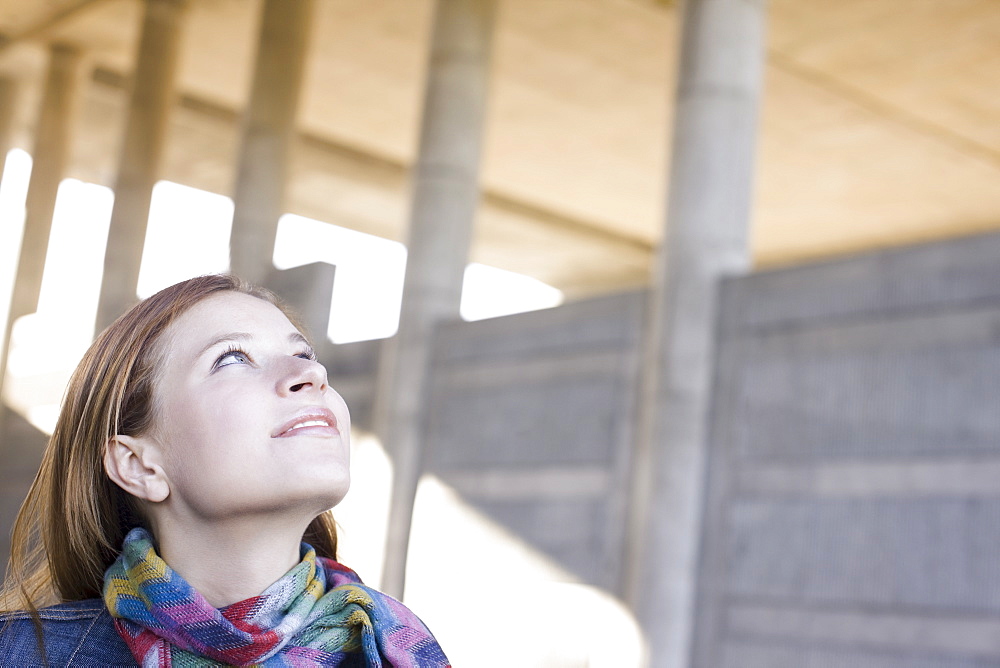 Young woman looking up