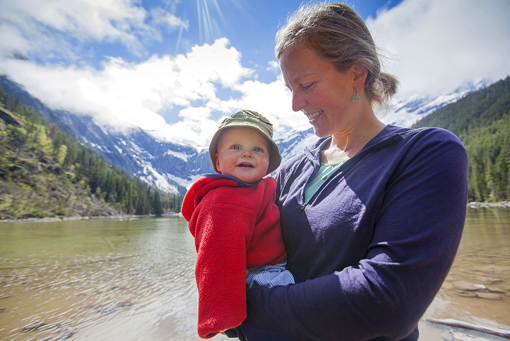 Portrait of woman with son (4-5) on lakeshore, Avalanche Lake, Glacier National Park, Montana, USA