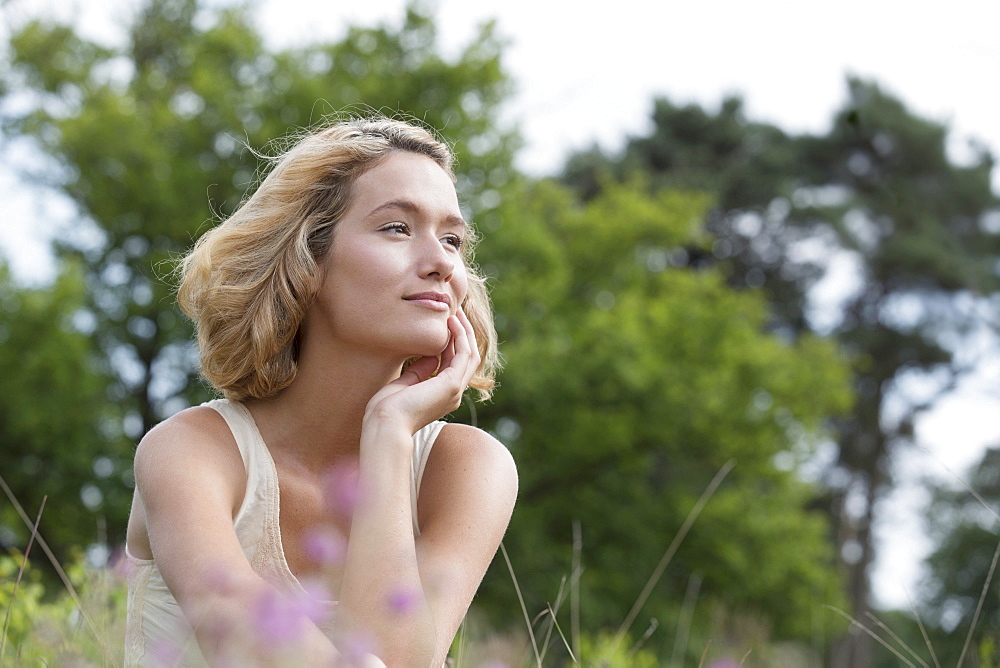 Woman relaxing on meadow, Netherlands, Gelderland, Hatertse Vennen