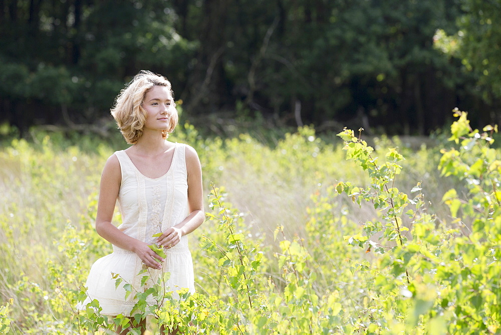 Woman relaxing on meadow, Netherlands, Gelderland, Hatertse Vennen