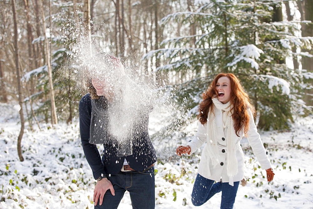 Young couple are having snowball fight