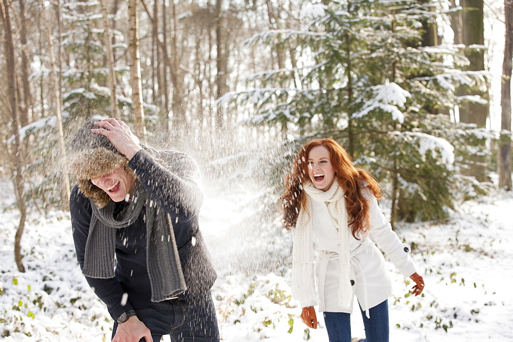 Young couple are having snowball fight