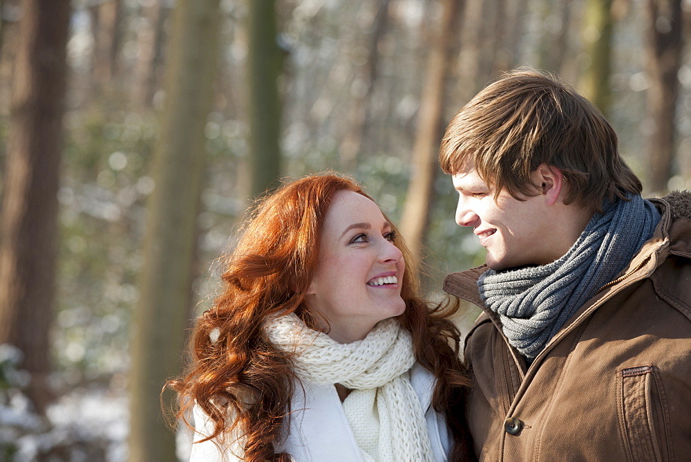 Young couple embracing in winter scenery